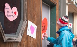 Volunteer Wheeling “Heart Bombs” The Friendly City for Valentine’s Day