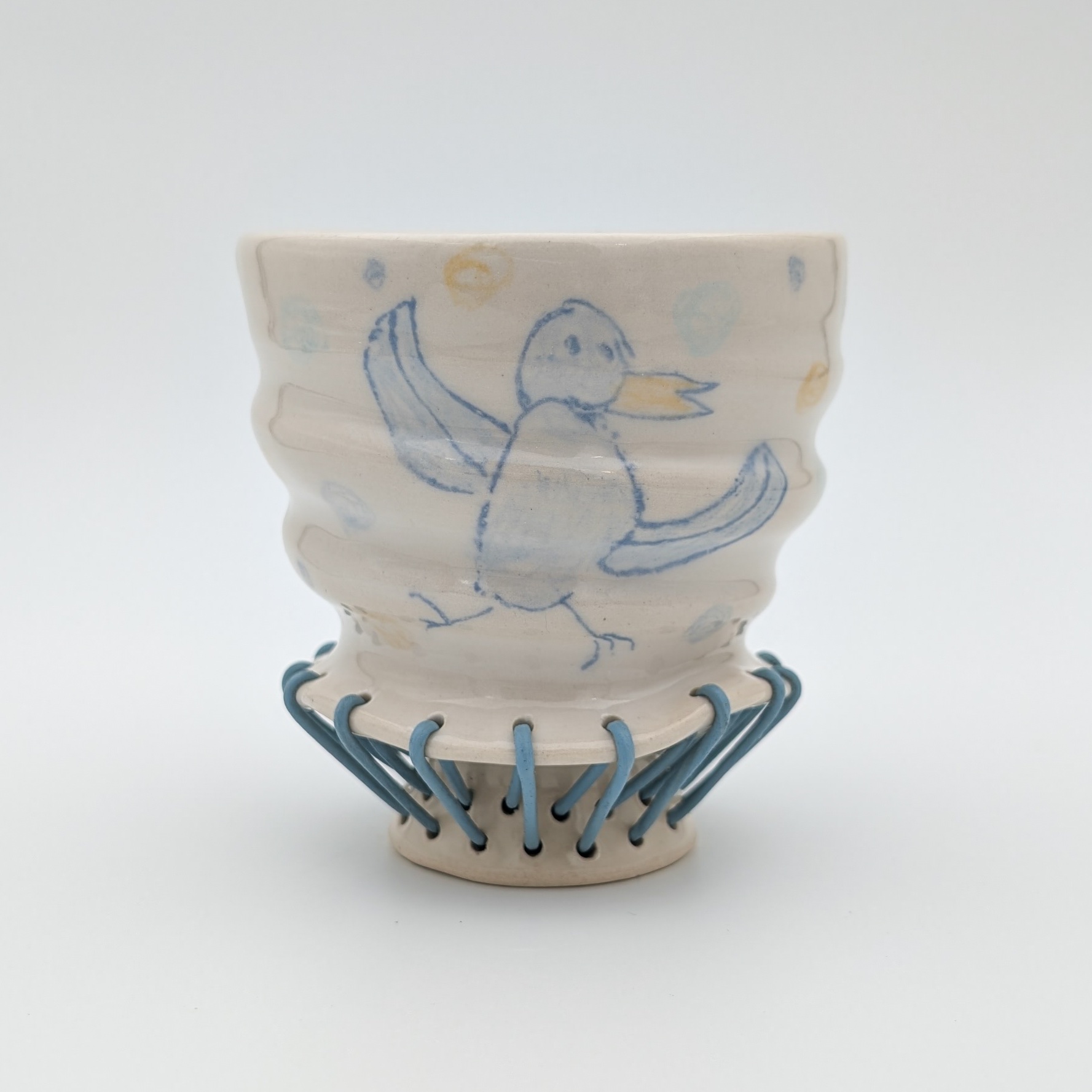 Ceramic, underglaze chalk, newsprint transfers, glaze