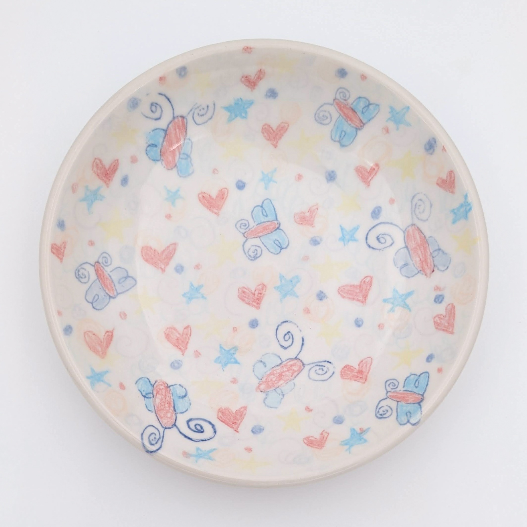 Ceramic, underglaze chalk, newsprint transfers, glaze